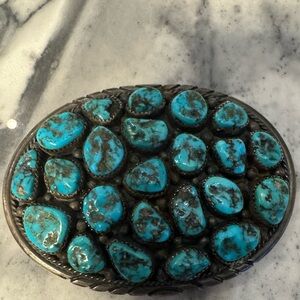 Magnificent vintage sterling buckle.a cluster turquoise stones. Signed L.James